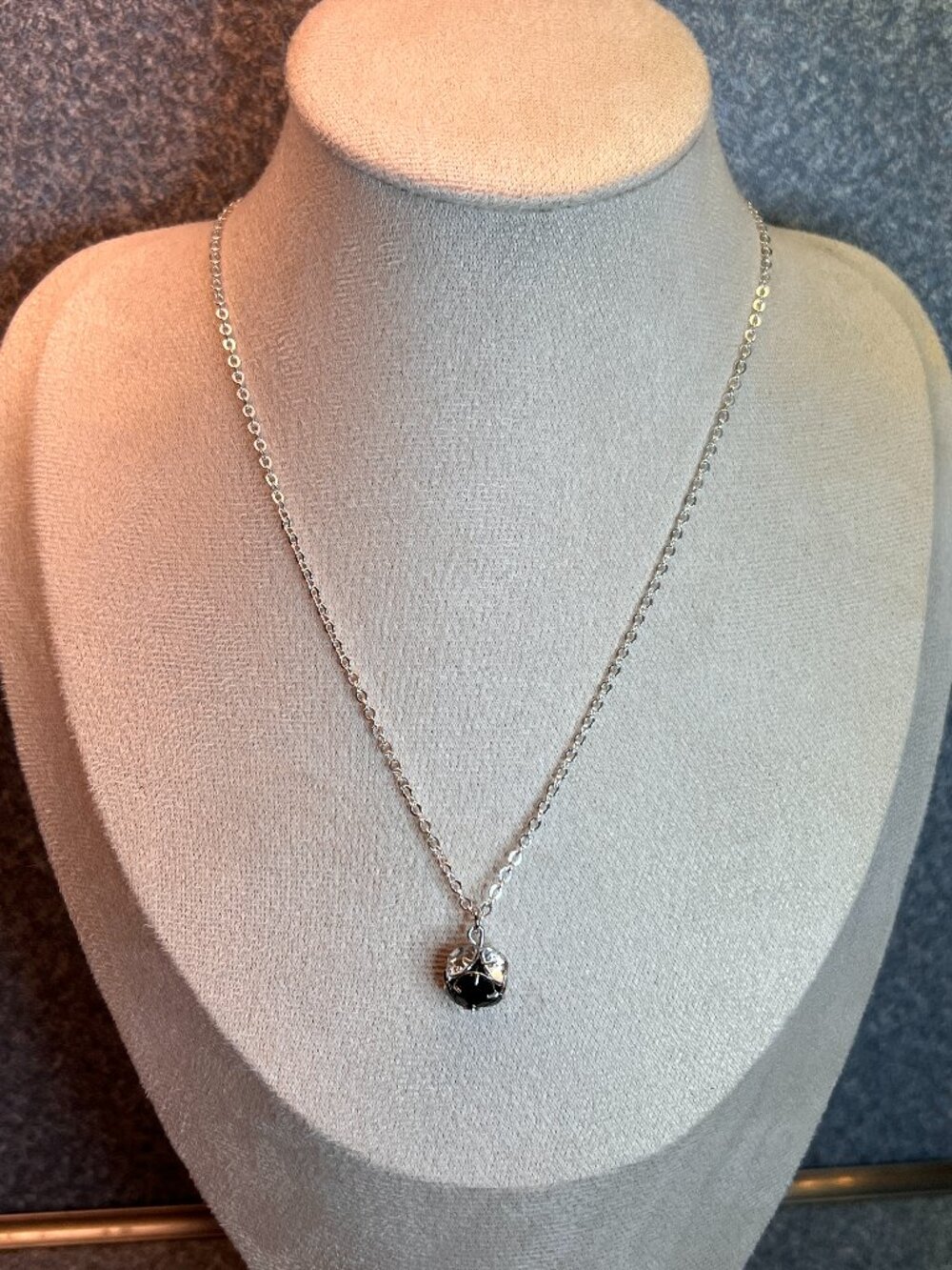 Swarovski necklace featuring round, dark red and clear crystals